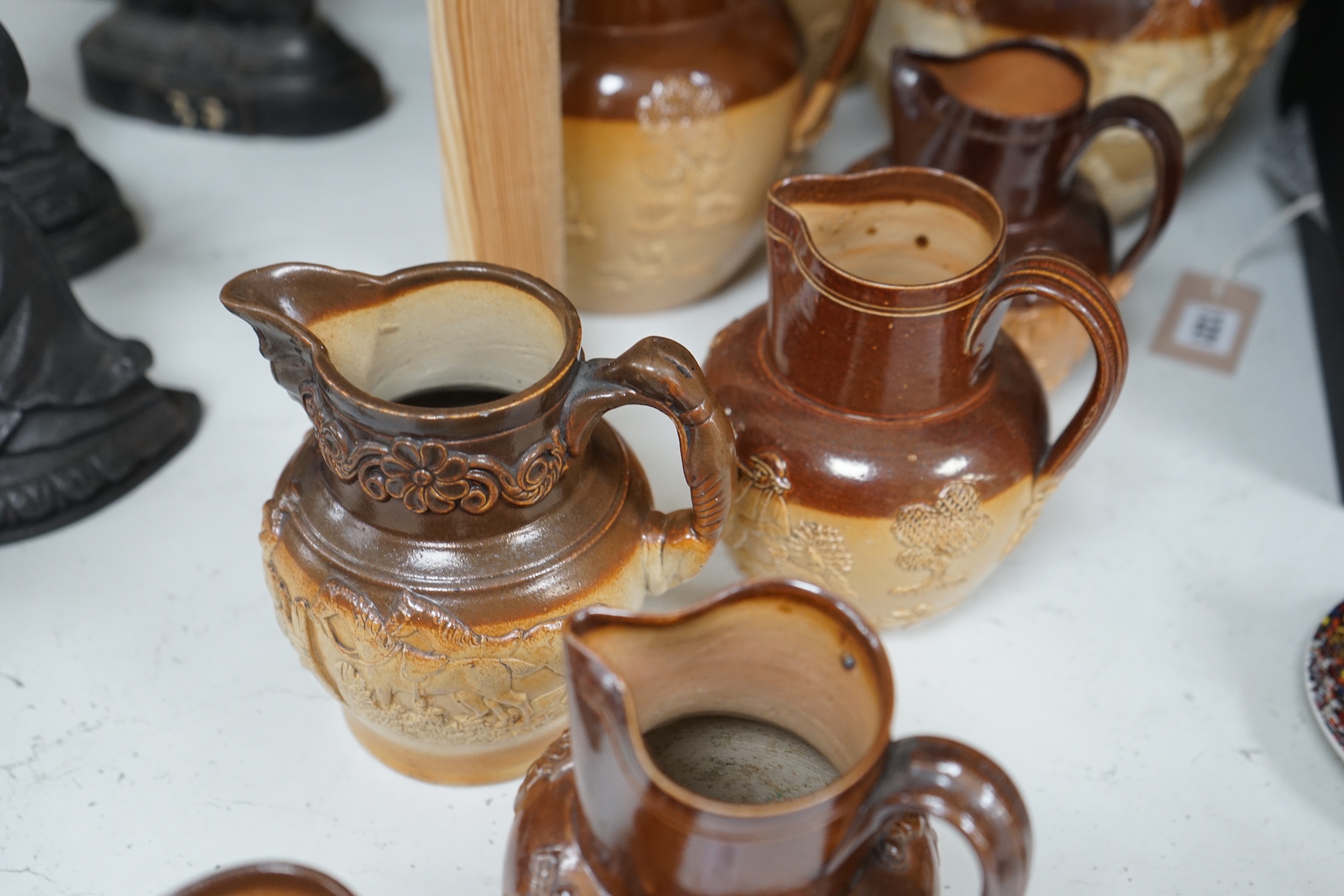 A group of eight Fulham & Lambeth salt-glazed stoneware jugs, tallest 22cm